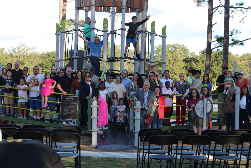 Families, city officials and other community residents celebrate the new all-inclusive playground at the Northwest Recreation Complex with an Oct. 24 ribbon cutting.