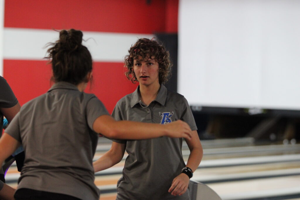 Samantha Carlisle and Madelynn Scofield slap hands after a strike