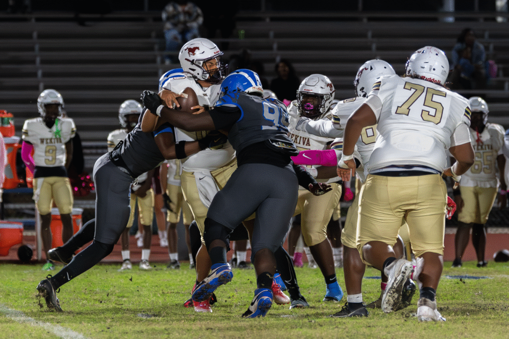 Three Blue Darters squash the Mustang Quarterback