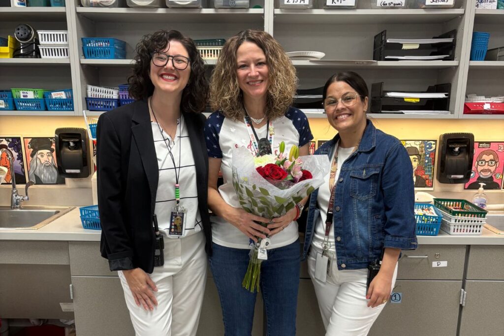 Principal Jessica Smith and assistant principal Jessica Starrett gave Tracey Scurrah red roses after she won Teacher of the Year at Clay Springs Elementary School.