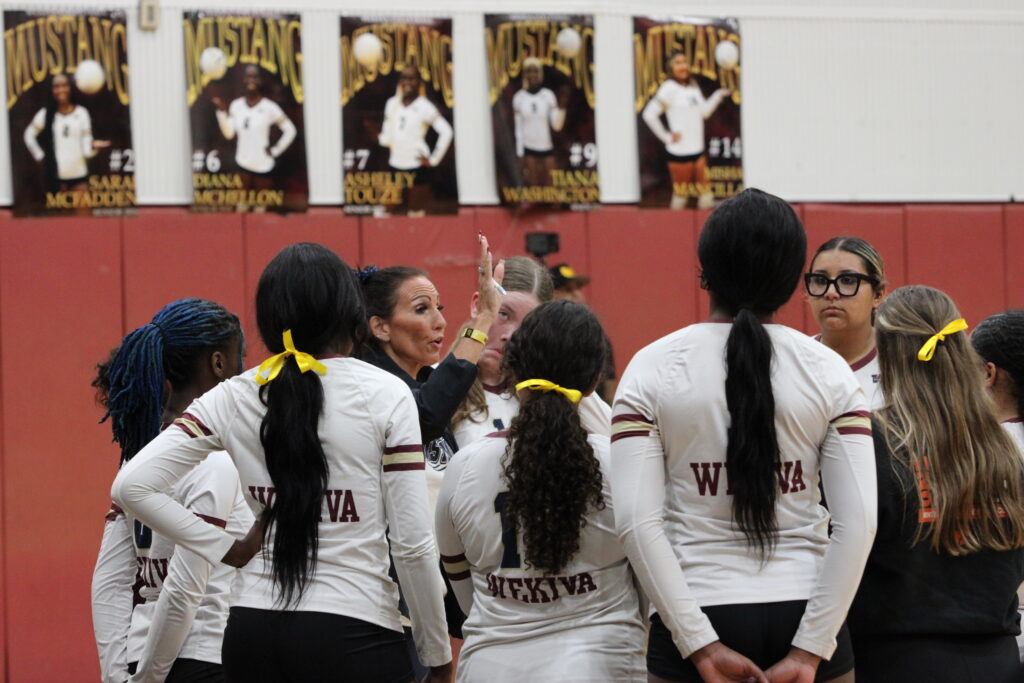Coach Lorenz talks to team after set one.