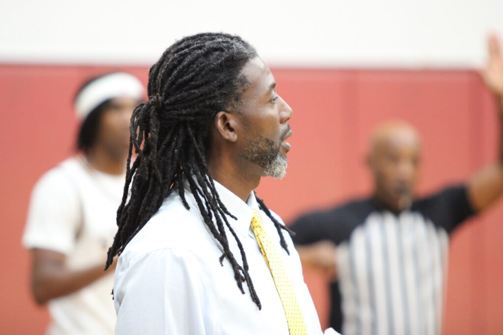 Coach Lubin communicating with his starters from the sideline