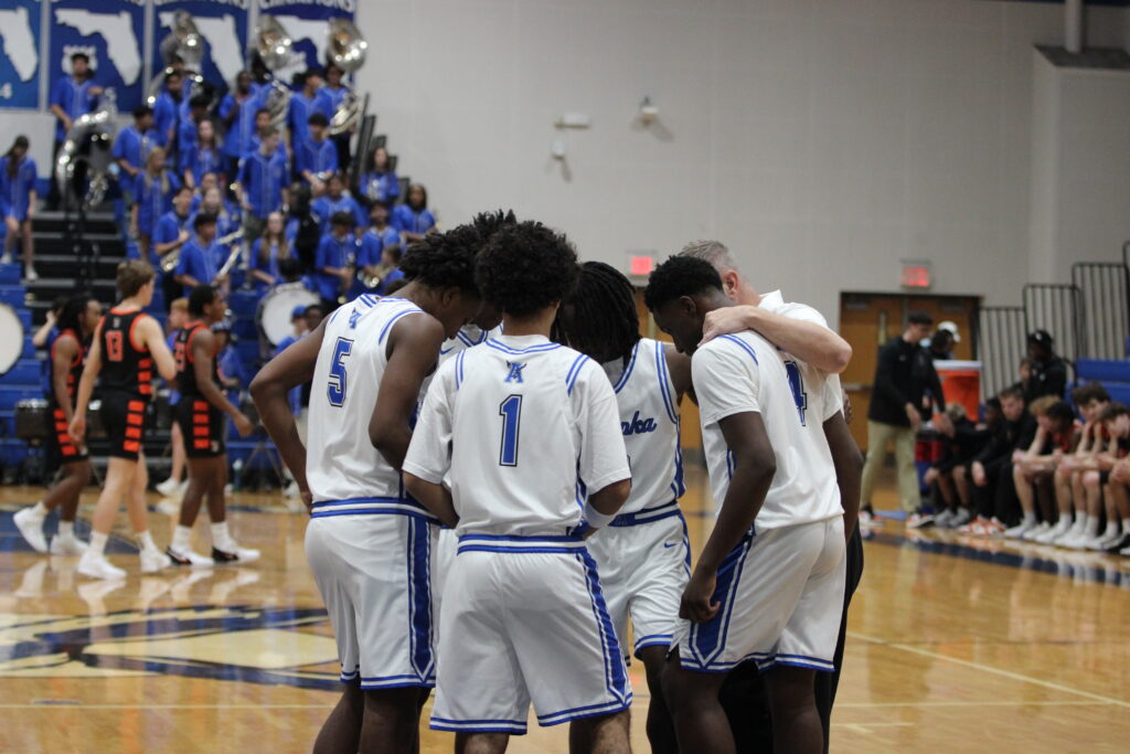 Coach Williams gathers the starters right before tip-off