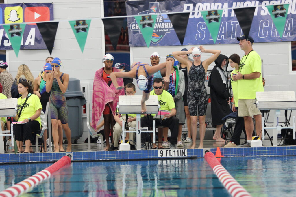 Druck plunges into the water to start the 400 free relay for her team