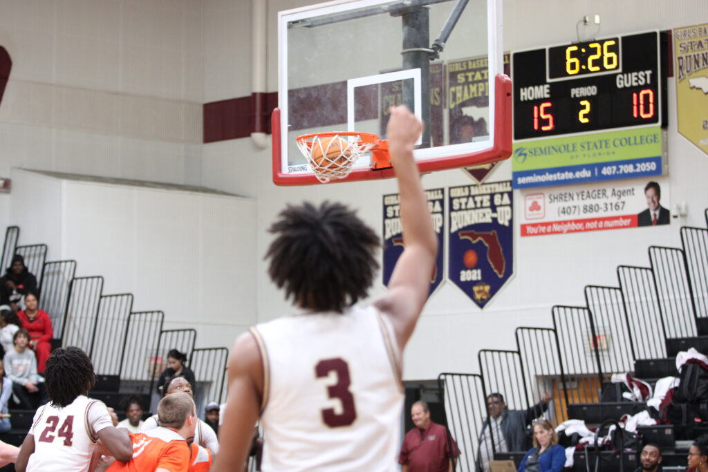 Eric Nicholls drains the three point shot