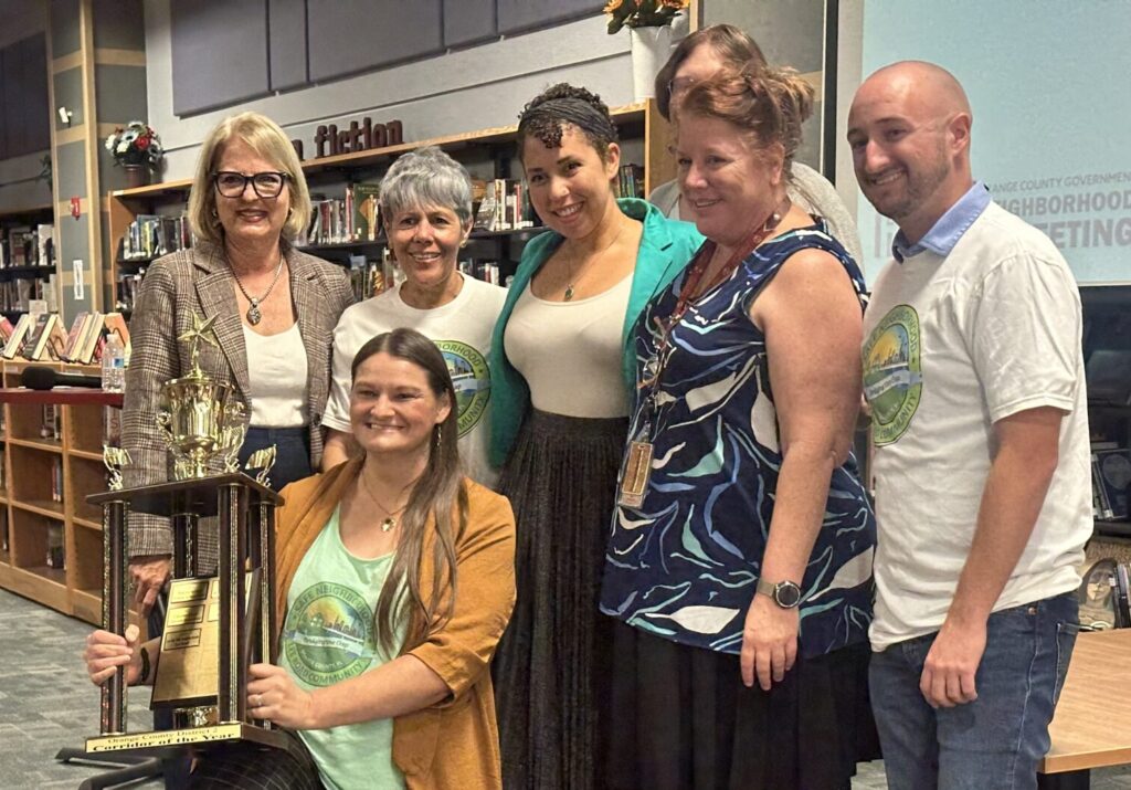 Lee Road Safe Neighborhoods receive Corridor of the Year for cleaning up and maintaining Lee Road in Orlando. Pictured with them is Orange County District 2 Commissioner Christine Moore (standing, L).