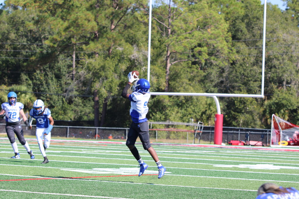 Kaden Willis catches a pass with nothing but grass in front of him