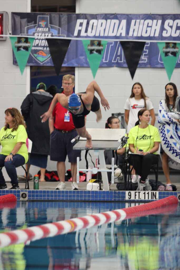 Maya Szylkowski launches off the platform to begin the 100 butterfly