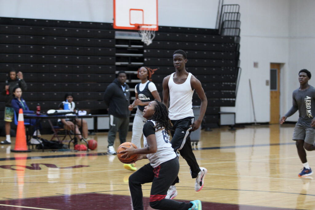 Players from the boys team help the girls with live action in practice