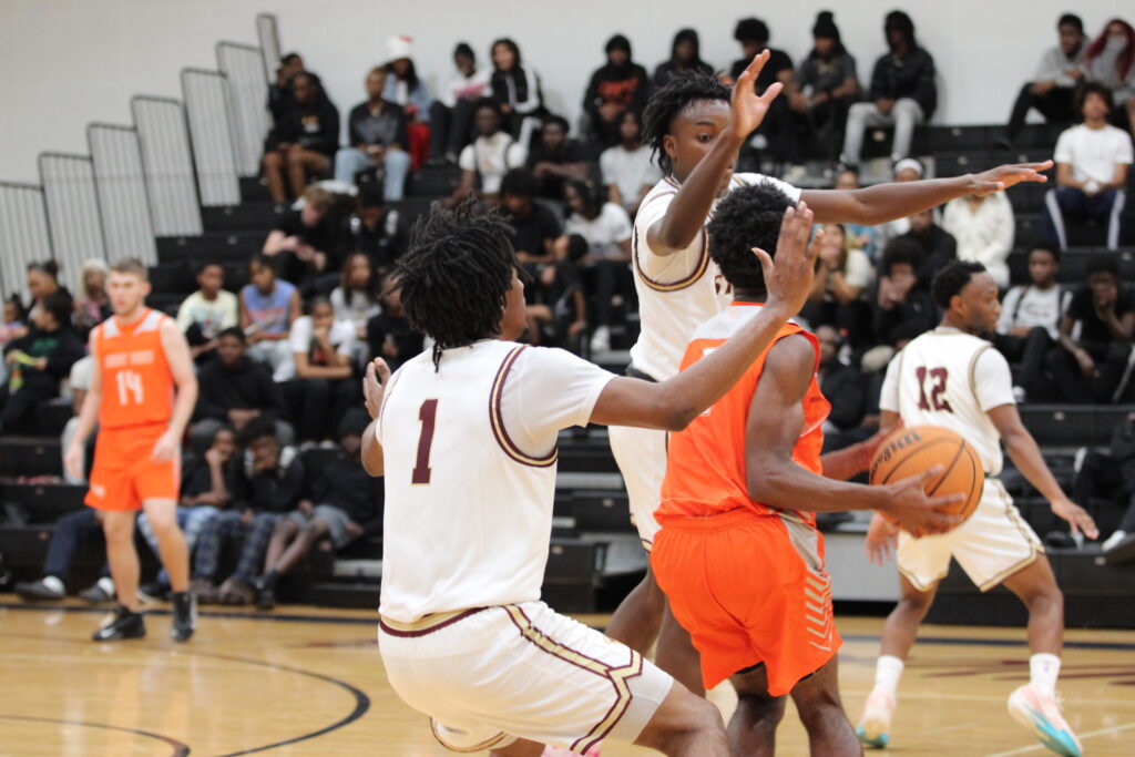 Darion Thomas and Louvens St Pierre trap the Hurricane player at half court