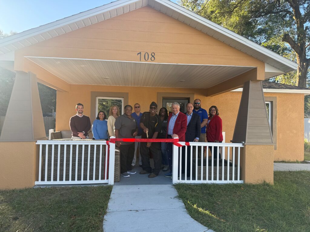 The Ivey family celebrates their new home with a ribbon cutting last week.