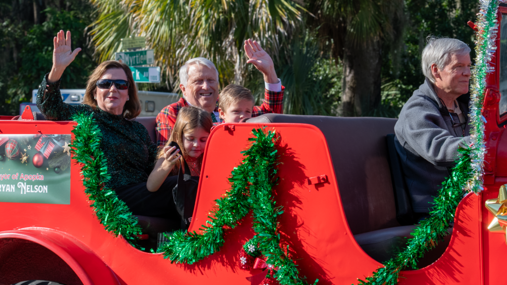 Mayor Bryan Nelson (center) waves with his wife Debbie (left) in a 1941 refurbished Dodge. Johnny Land (right), son of longtime Mayor John Land, recently finished another refurbishment on the vehicle, which he said last ran in the parade around 2000. It's been in the Land family since 1946.