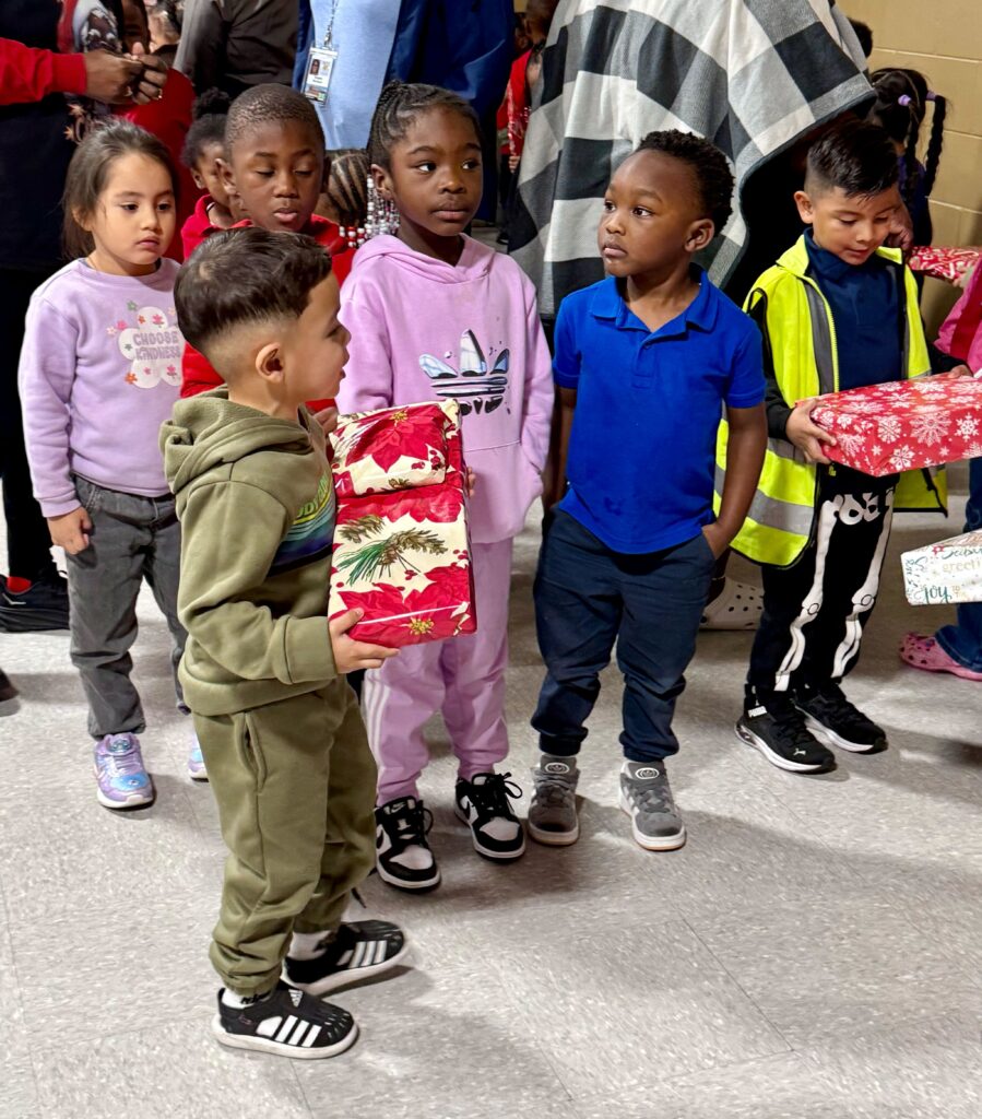 Children from Head Start receive their presents from the Apopka Progressive Seniors Club.