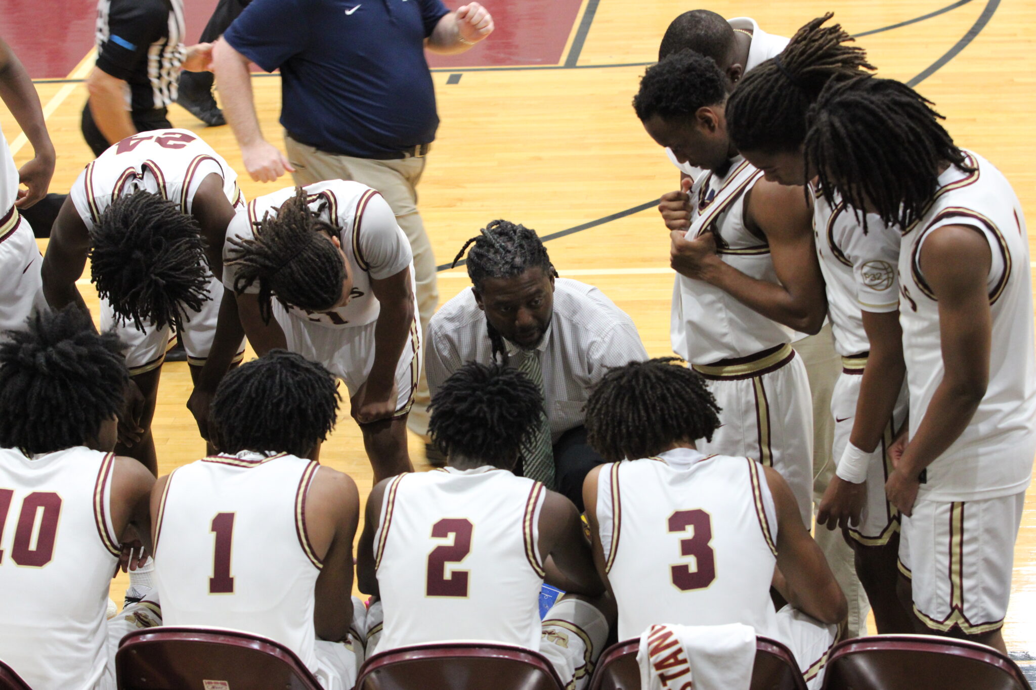 Coach Lubin corralles the team through the slow start