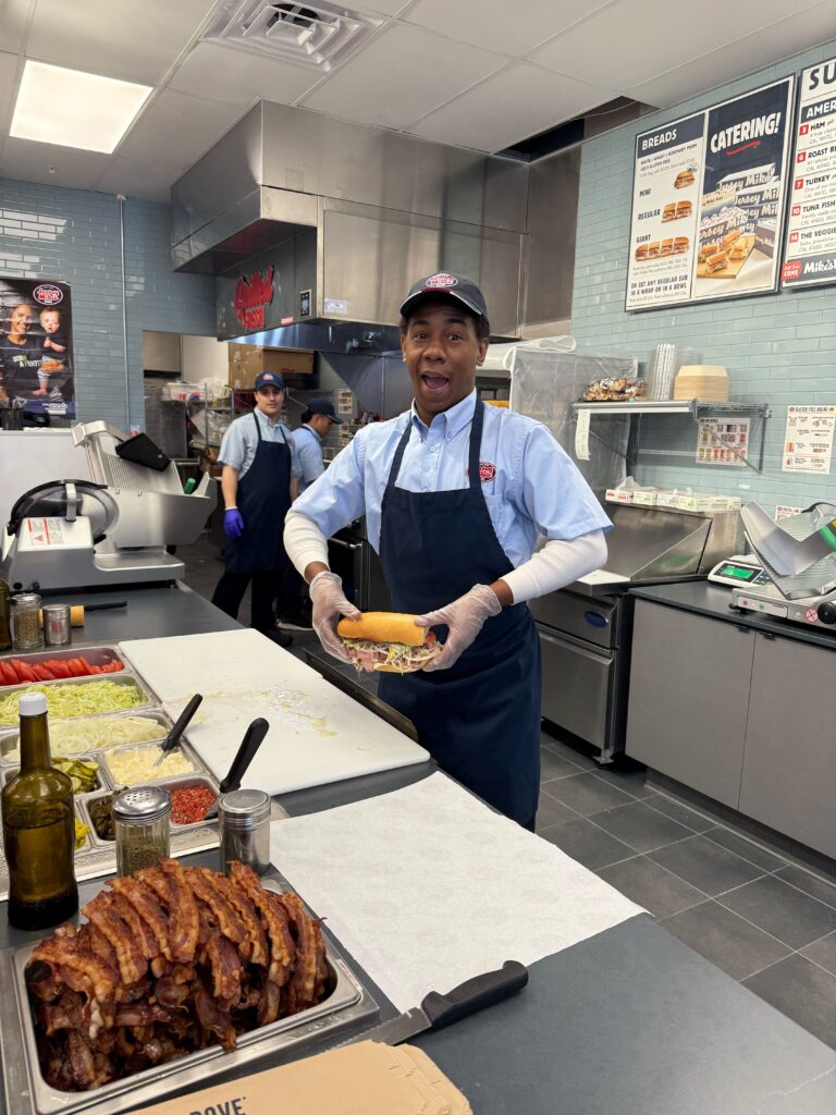 Darius Daniels poses with the third sub of the day—the #9 Club Supreme, which includes roast beef, turkey, Swiss, applewood smoked bacon and mayo.