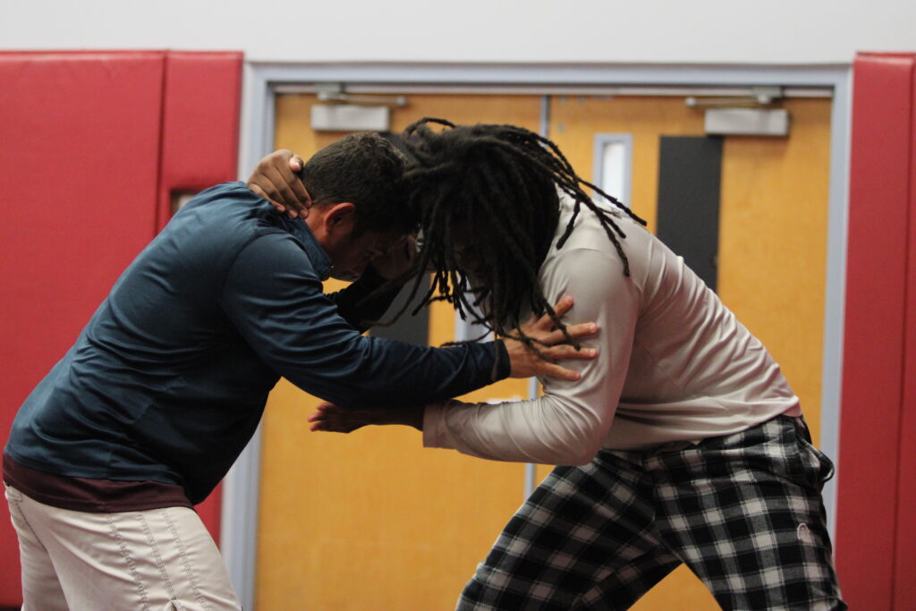 Elijah Jean and coach Lenin Vazquez drill together