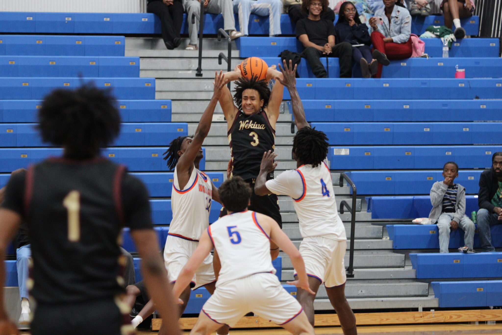 Eric Nichols taking on three defenders