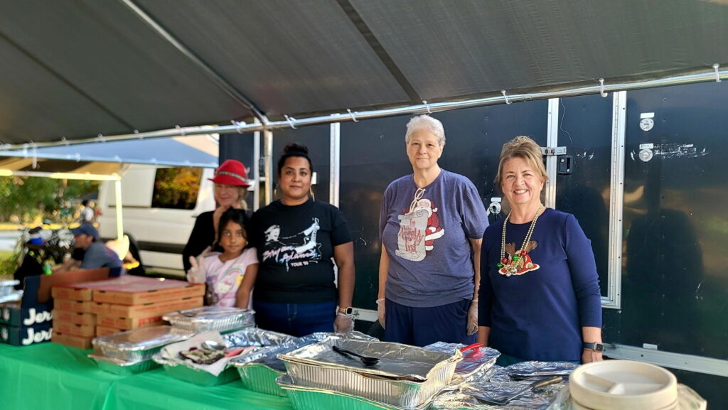 Volunteers serve the homeless population meals at a special Christmas celebration on Sunday.