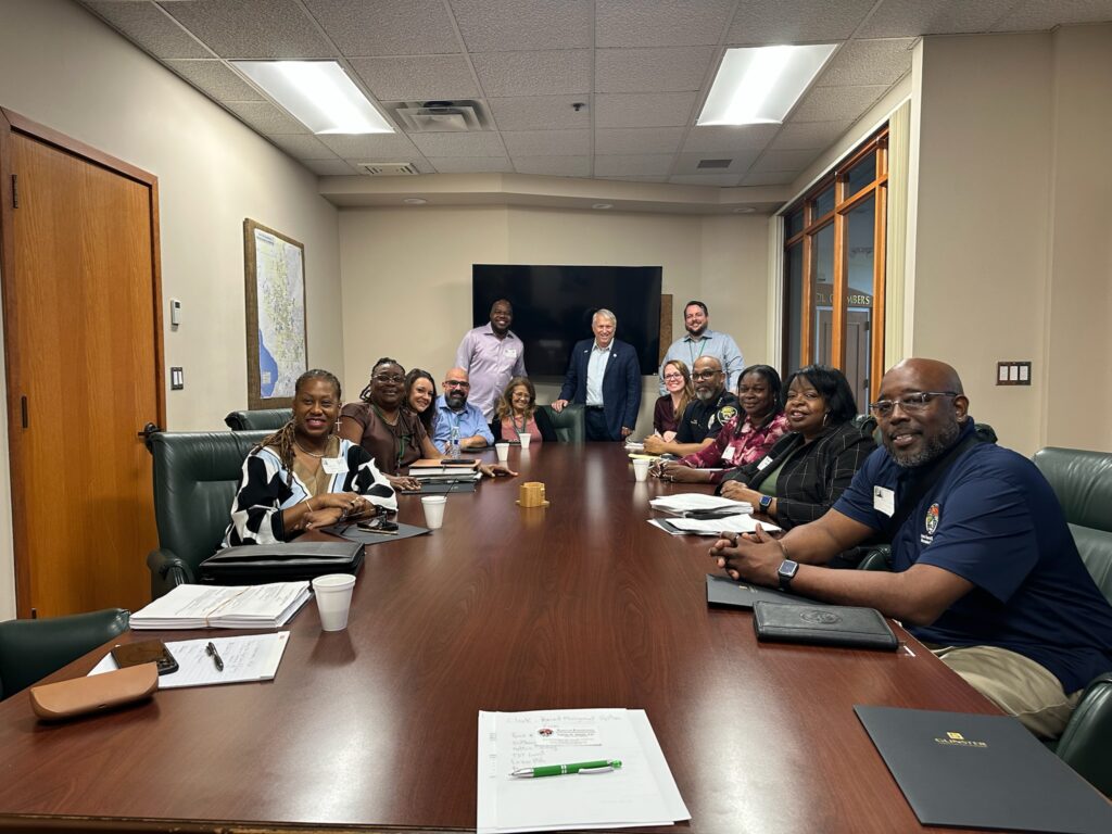 Representatives from Eatonville and Apopka, including Mayor Bryan Nelson and Eatonville city administrator Marlin Daniels, meet in a conference room at Apopka City Hall.