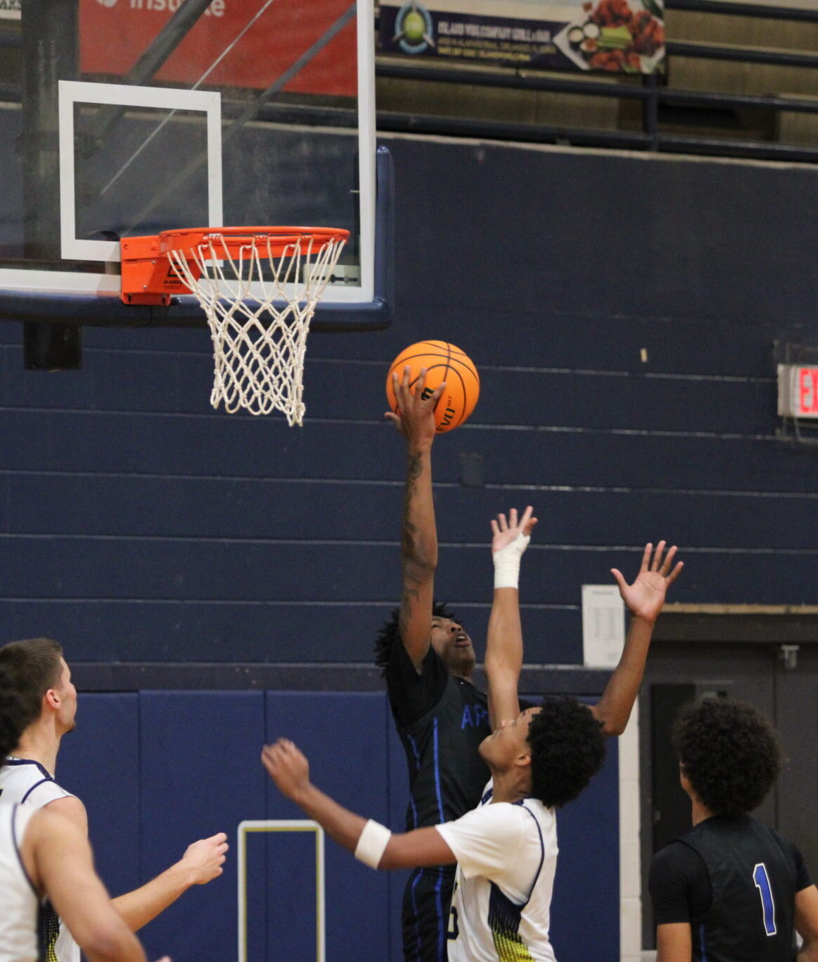 Jarquavion McClain snags the rebound over a Cougar