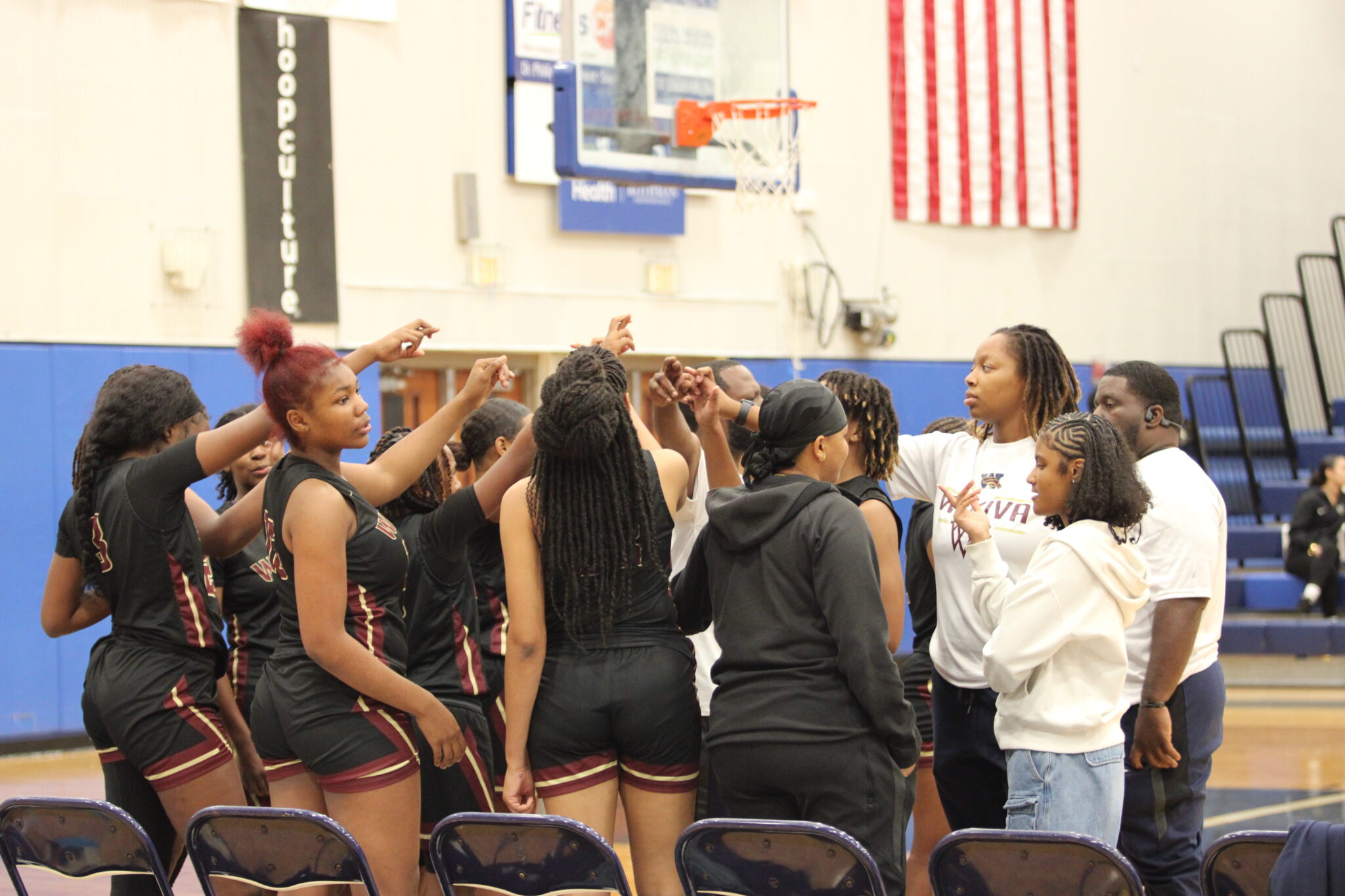 Lady Mustangs break huddle at the end of the third quarter against Dr. Phillips