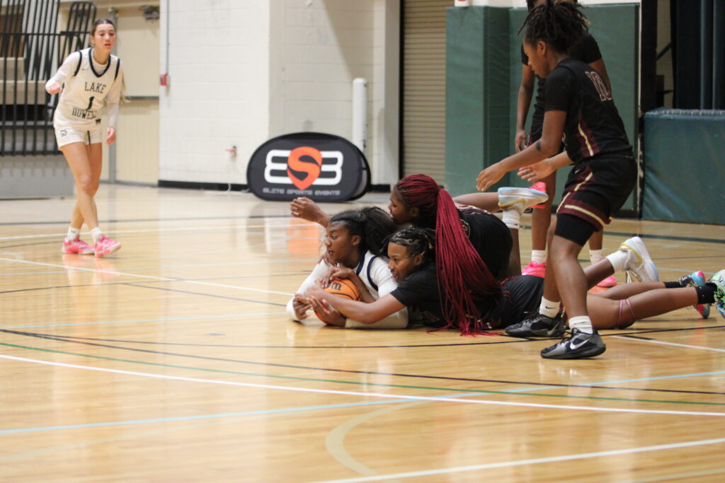 Makayla Bell and Tiana Washington battle a Hawk for the loose ball