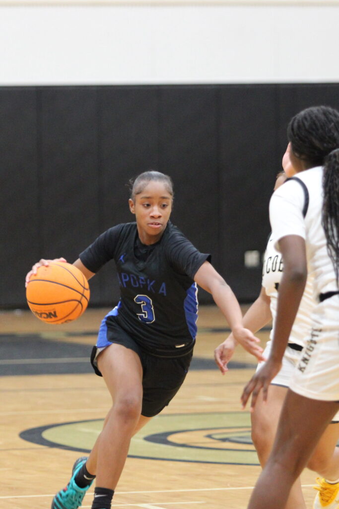Mikayla Wiggins drives into a lane toward the basket