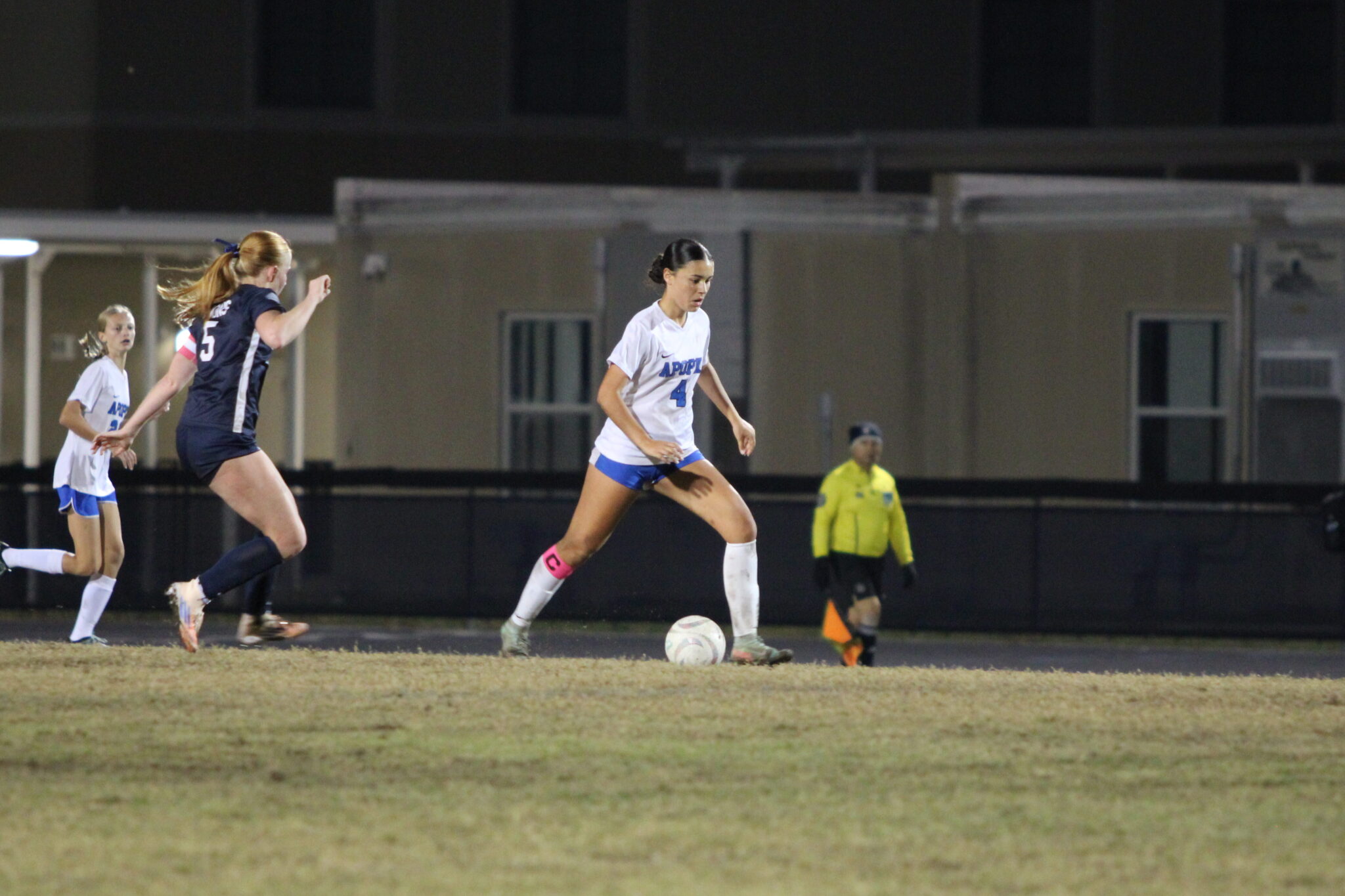 Nevaeh Nguyen dribbles past defenders up the pitch