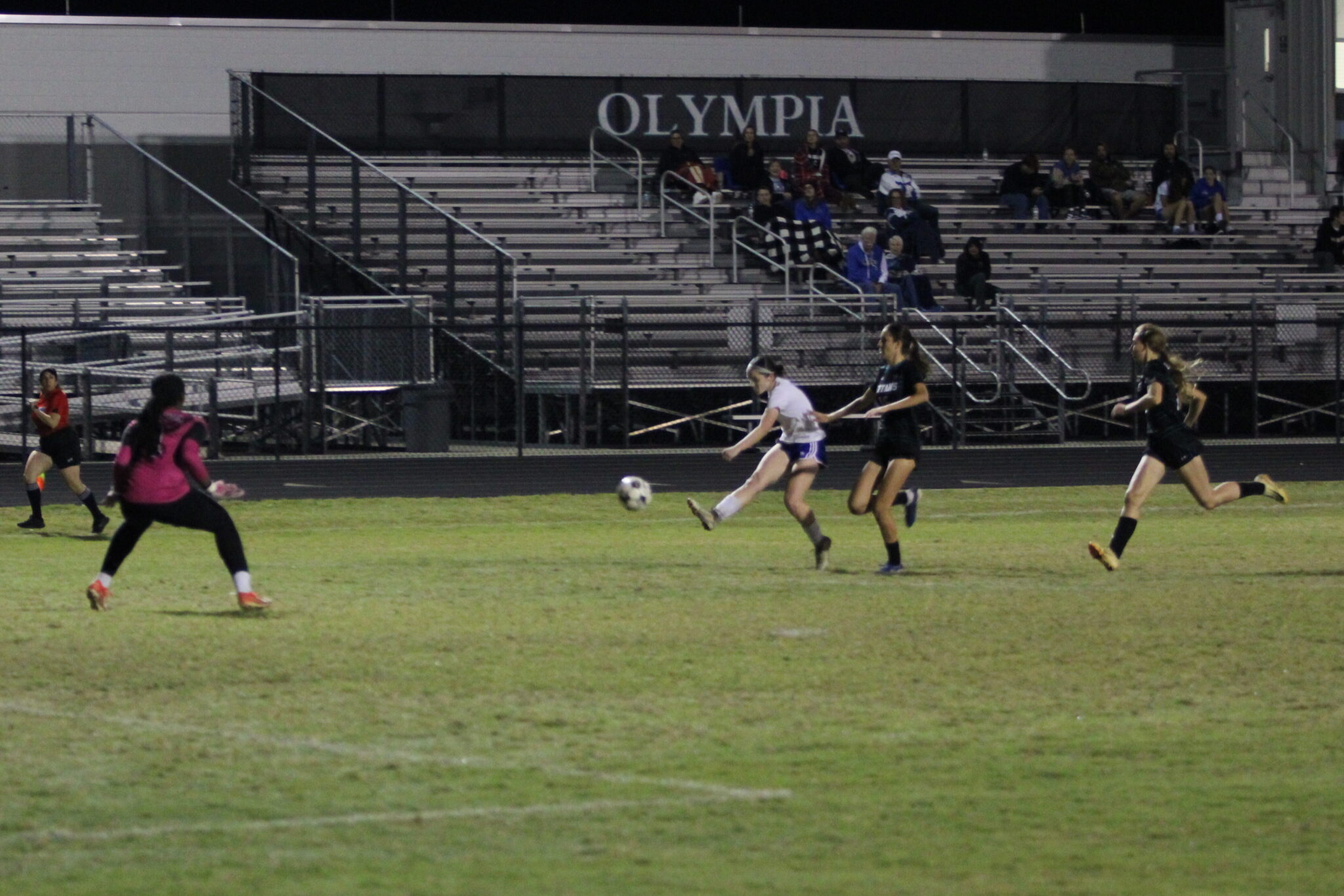 Robyn Pickard launches a kick from outside the box over the goalies head