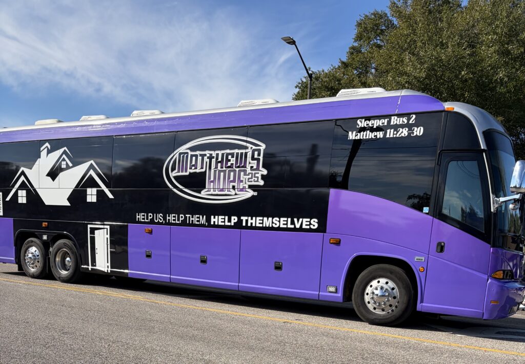 A Matthew's Hope sleeper bus rolls along North Park Avenue in the Apopka Christmas Parade.