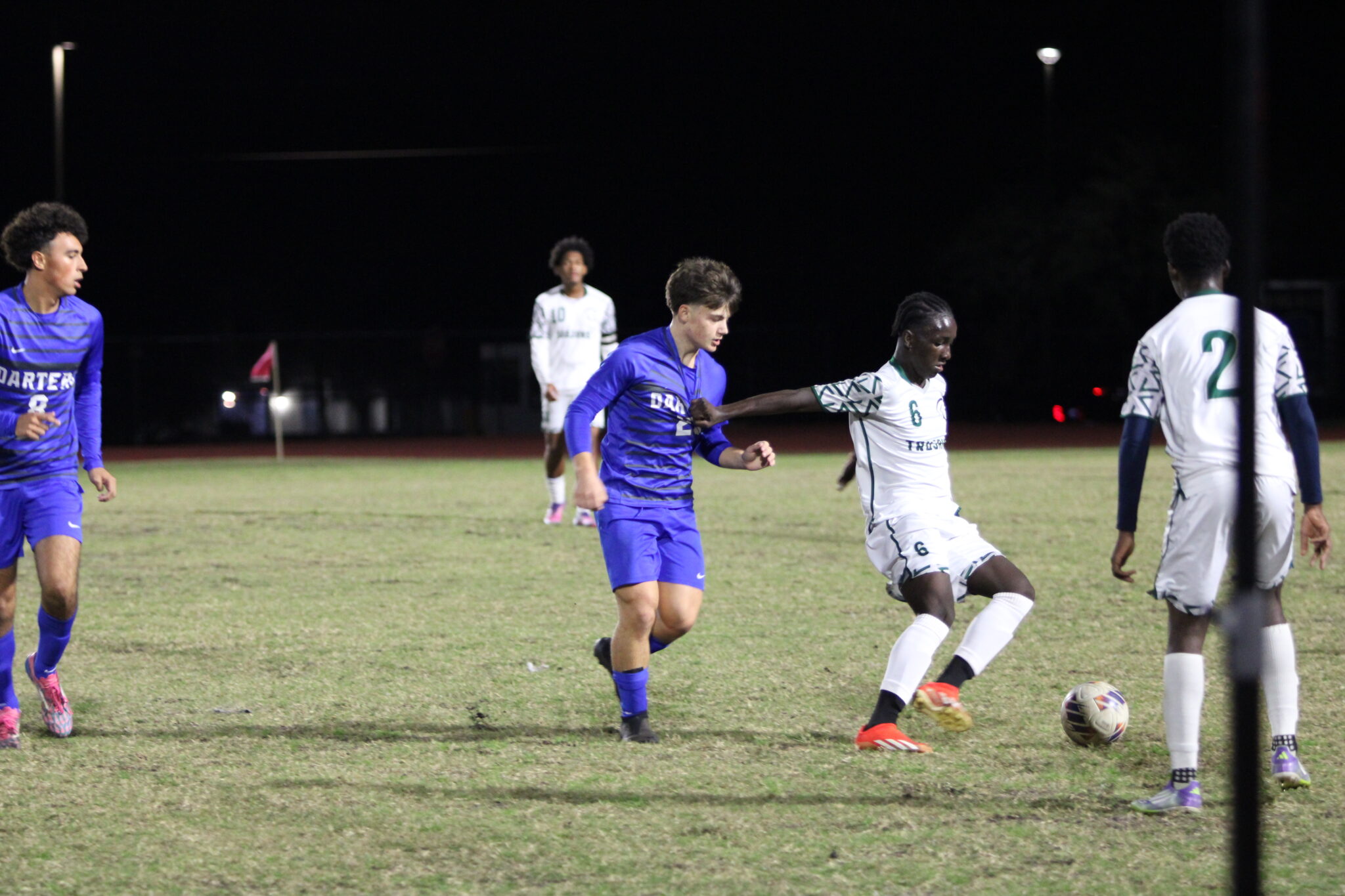 Wesley Hyatt gets his shirt tugged by a Trojan