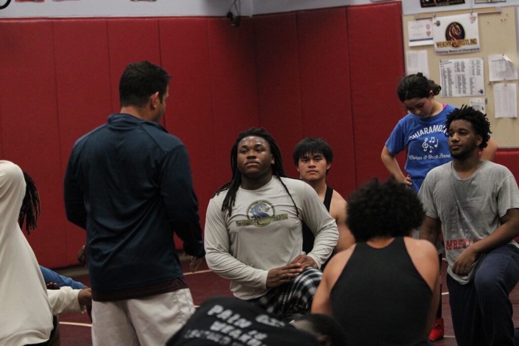 Wrestlers listen to Coach Vazquez after practice