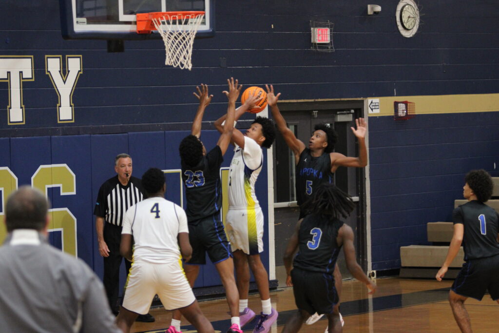 Xavier Freeman and Noah Ferrer contest and block the Cougar's shot