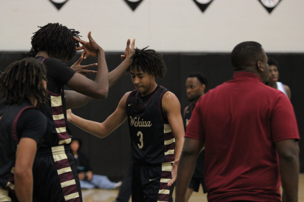 Eric Nichols hits a 3 right in front of his bench