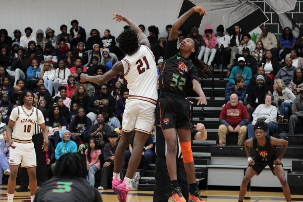 Kenny Dieujuste jumps for the opening tip-off
