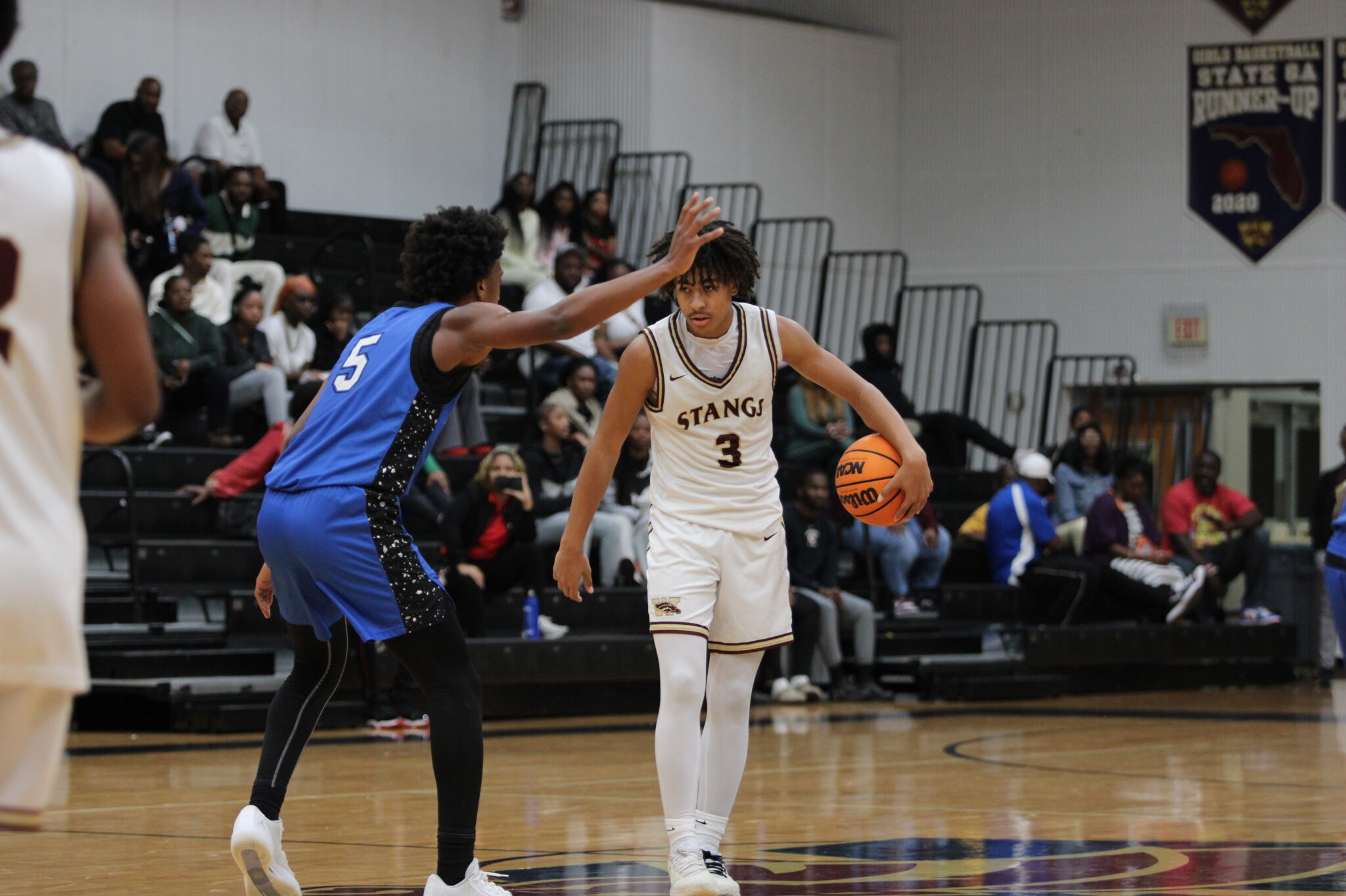 Noah Ferrer and Eric Nichols face off at the top of the key