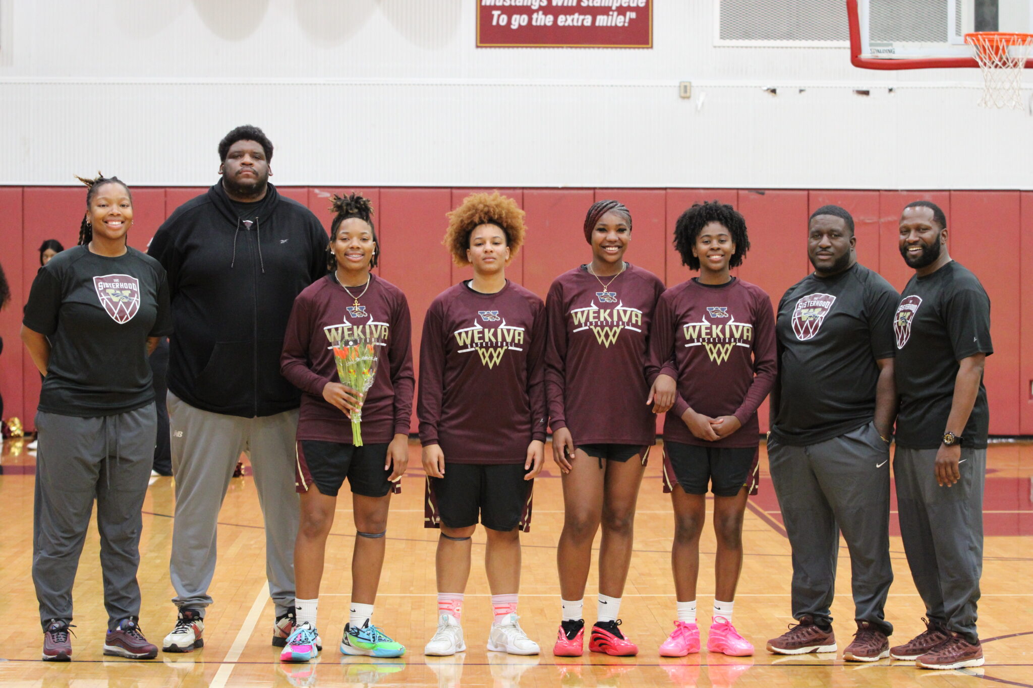Senior Lady Mustangs pose with their coaches