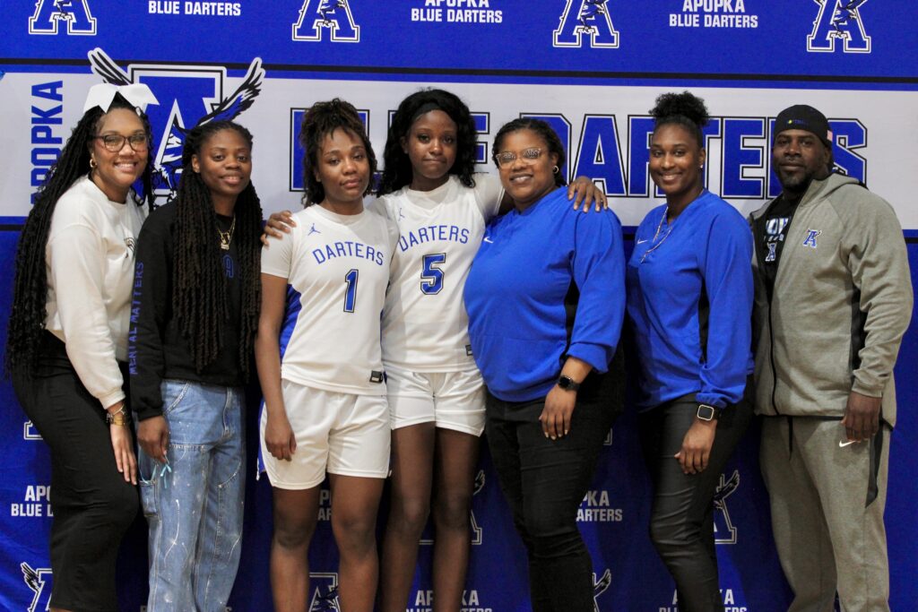 Seniors Elyse Pringle(1) and Abigail Henry(5) pose with the coaches postgame
