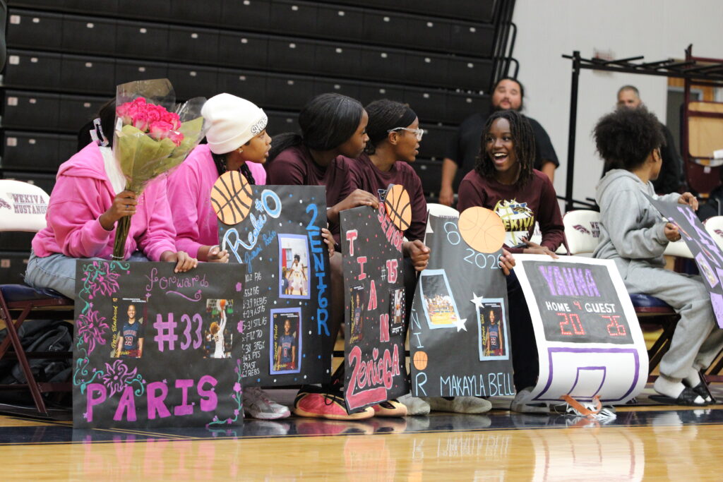 Wekiva Mustangs hold up signs on their bench for the seniors