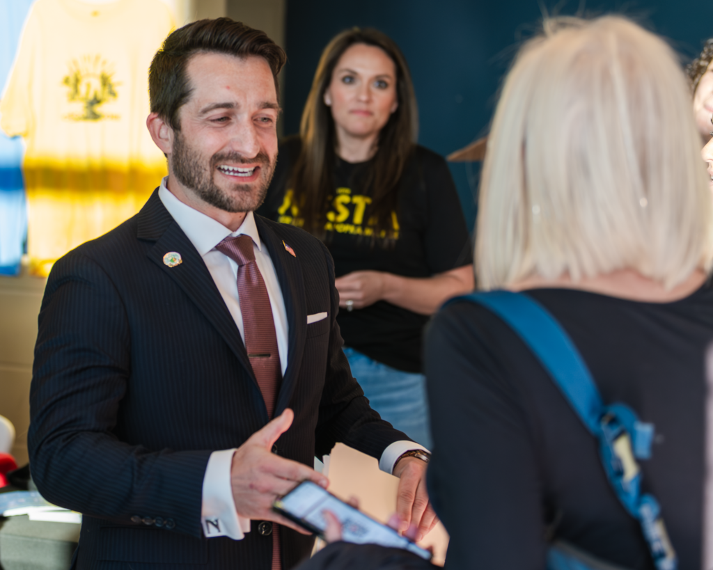 Nick Nesta shakes hands with an attendee ahead of the Feb. 3 mayoral debate.