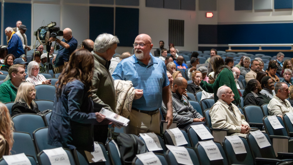 Attendees greet each other at Apopka High School before the debate begins.