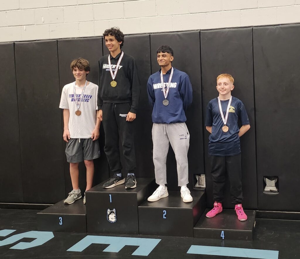 Landonn Shultz stands on the podium at the District championship