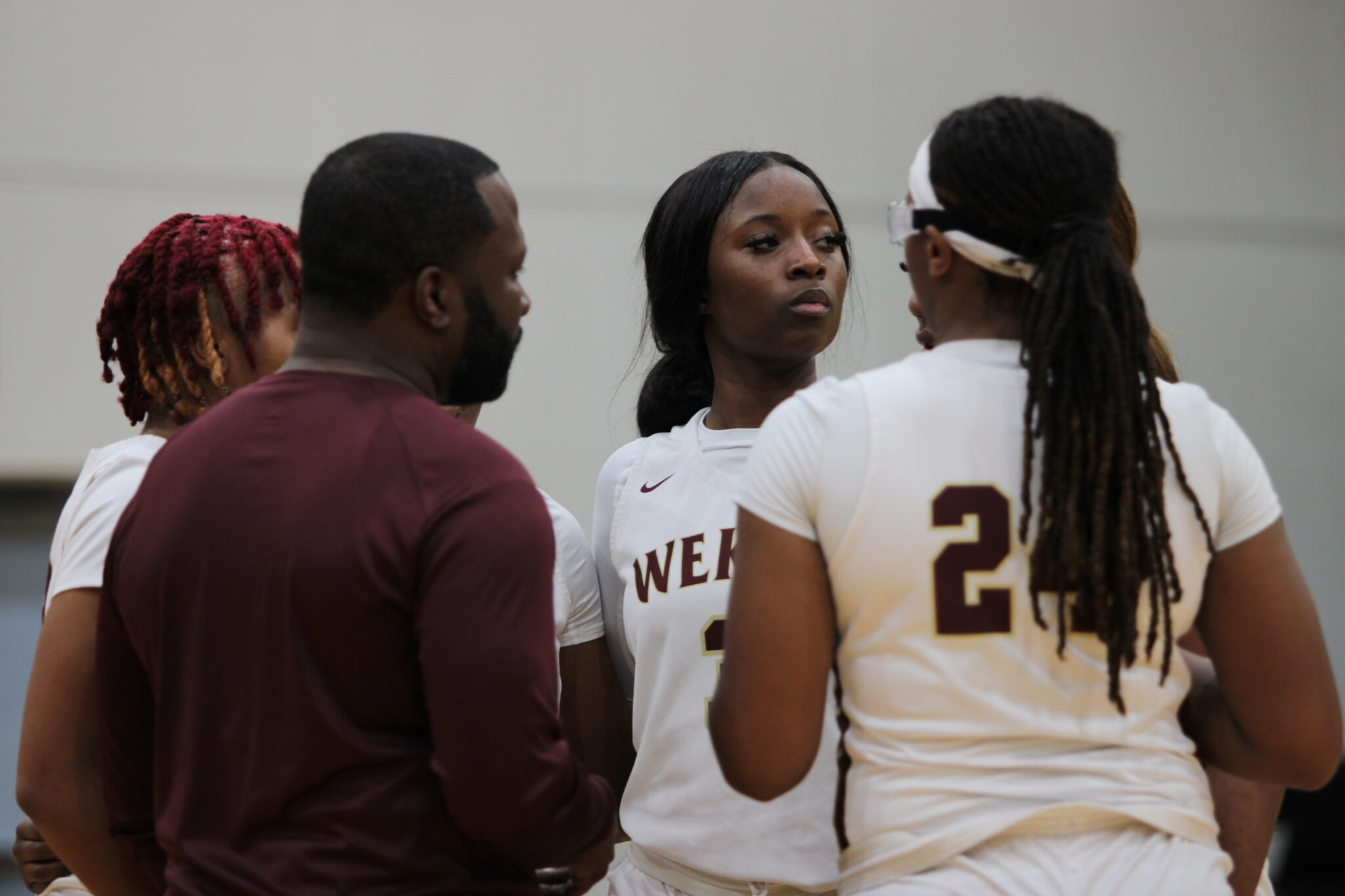 Coach Jerry Middleton talks to his starting lineup before the tip-off