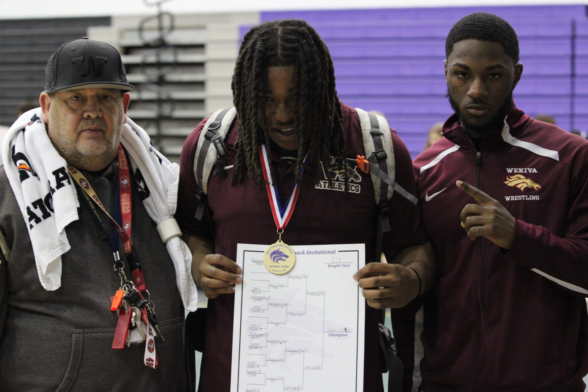 Coach Tony Imbriani, Elijah Jean, and Mustang Alum Demarcus Stokes pose after gold medal win