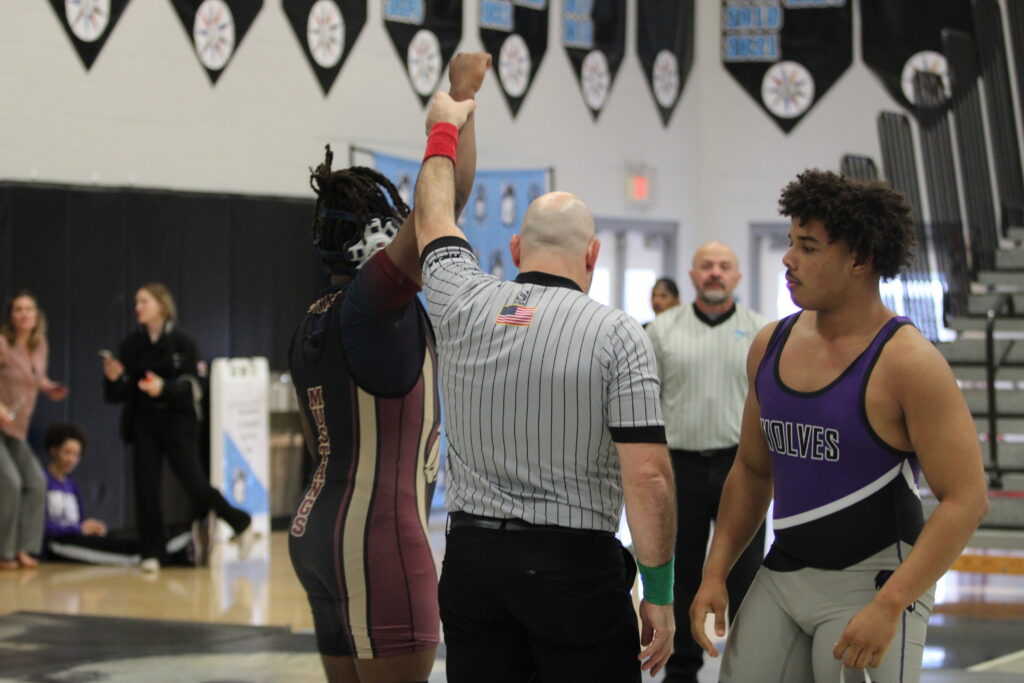 Elijah Jean gets his hand raised to advance to the district championship final