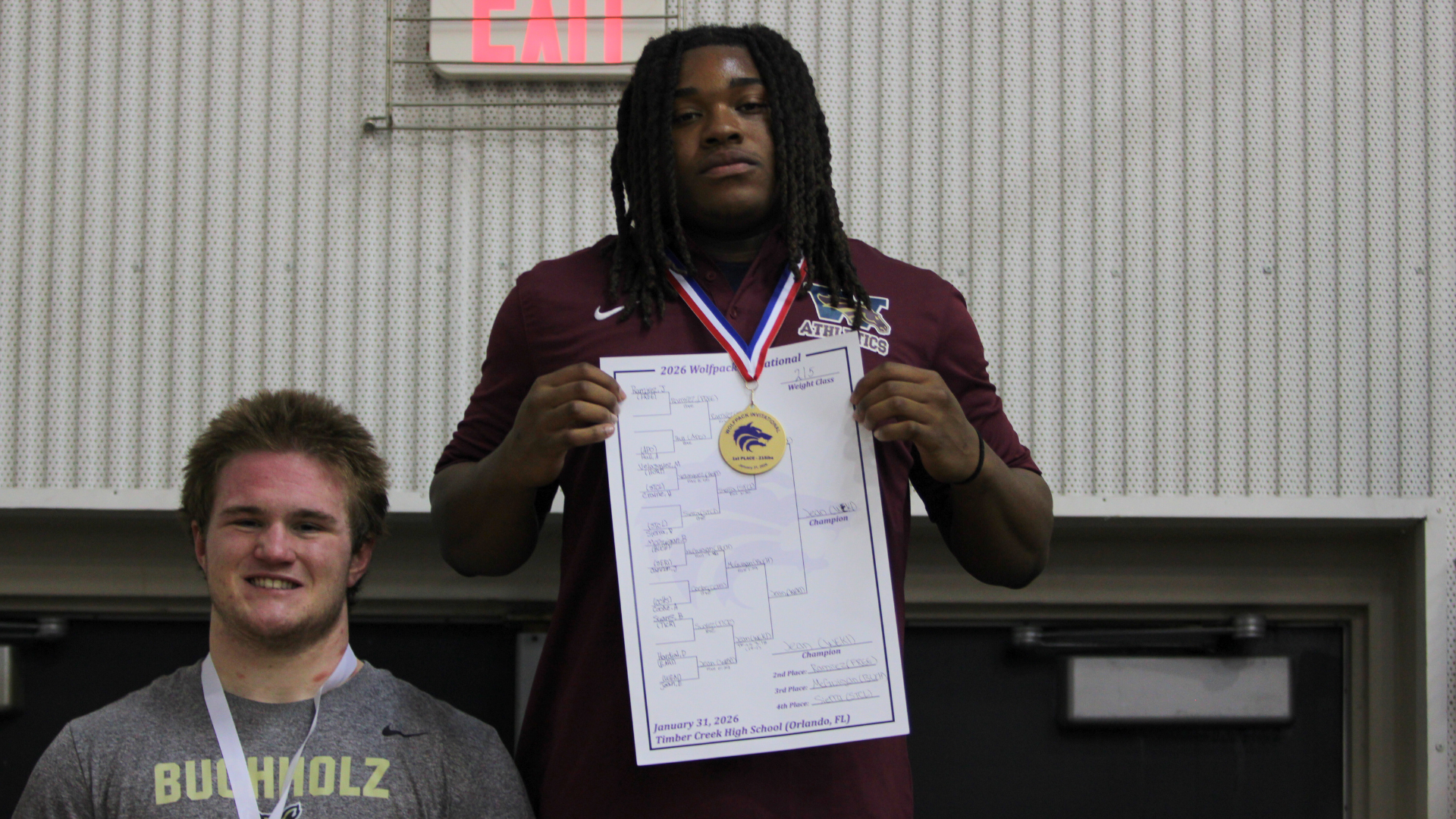 Elijah Jean stands at the podium with his gold medal