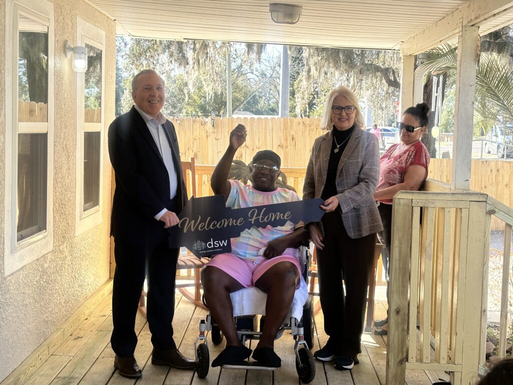 Lorenzo Turner (C) is with Mitchell Glasser, manager of the Orange County Housing and Development Division (L), Orange County Commissioner Christine Moore (second from R) and Turner's friend Carmen Santiago (R). Photo by Teresa Sargeant