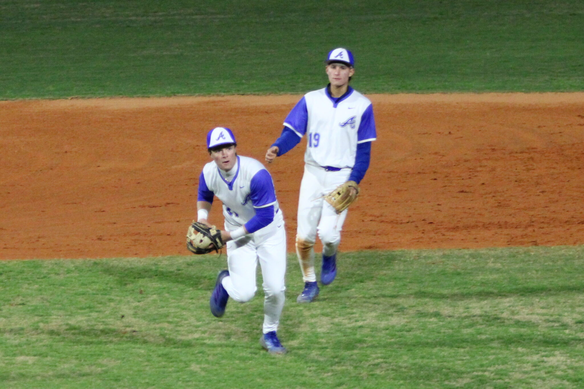 Jez Hamrick digs for the choppy grounder and guns out the runner at first