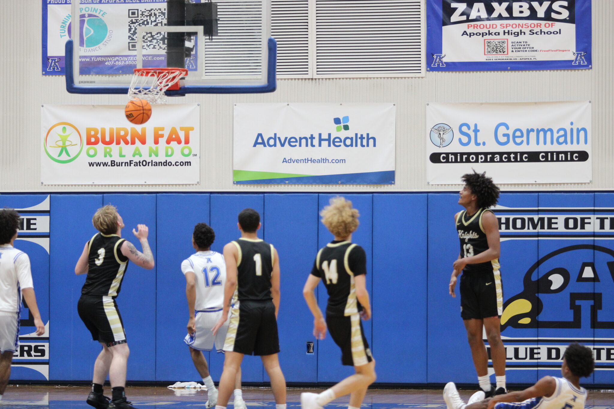 Noah Ferrer sinks the clutch fadeaway basket, falling to the floor.