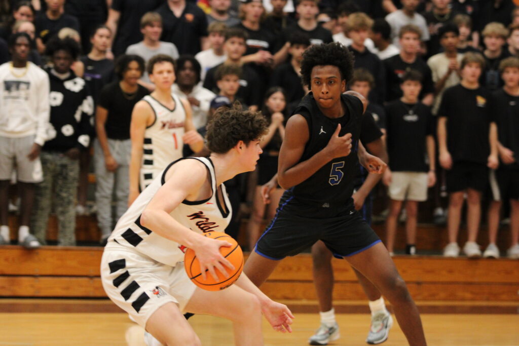 Noah Ferrer slides his feet to stay on his man late in the regional semifinal against Winter Park